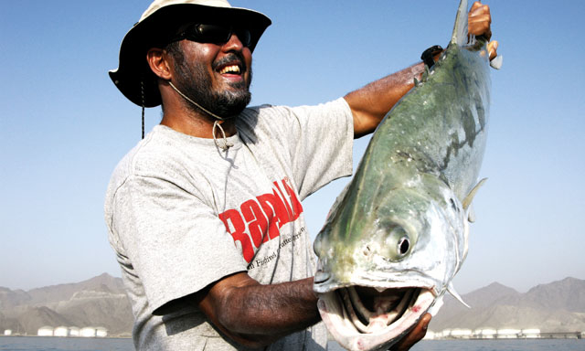 Fish-hugging man smiles for camera thebookongonefishing